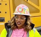 Women wearing safety jacket and helmet